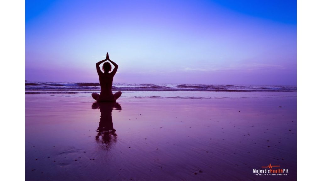 Woman doing yoga on the beach for stress relief and flexibility"