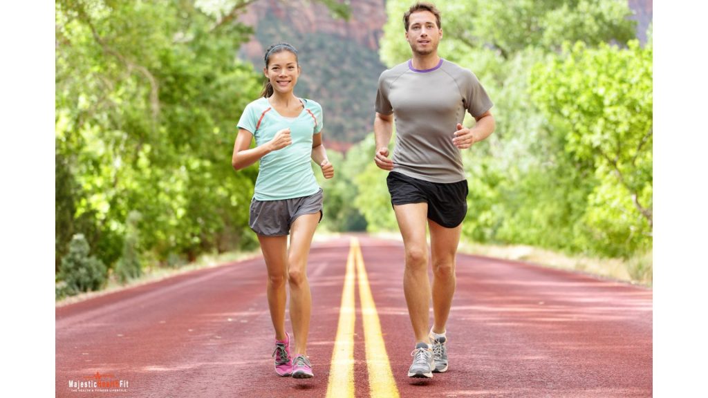 A couple running on a rural road, embracing health and fitness tips for a balanced and active lifestyle."